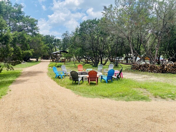 A gravel path leading to a grassy area with outdoor seating and a gazebo.