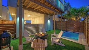A backyard with a pool, a fire pit, and Adirondack chairs. - Southern Cross by Avantstay Steps to the Beach, Pool, Fire Pit & Direct Boardwalk Access (Port Aransas)