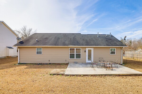 A single-story house with a front porch, a small patio, and a garage. - Family Home in Fountain Inn, 2 Mi to Main St! (Fountain Inn)