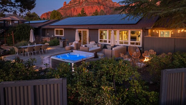 Ein Wohnhaus mit Terrasse, Sitzgelegenheit im Freien, Whirlpool und Bergblick.