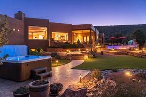 A modern house with a hot tub, outdoor seating, and a fire pit area. - 5.5k Sqft Luxury Home with Large Suites, Views, Hot Tub & Firepit (Sedona)