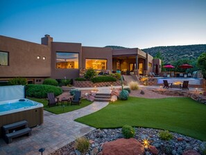 A modern house with a patio, hot tub, and outdoor seating area. - 5.5k Sqft Luxury Home with Large Suites, Views, Hot Tub & Firepit (Sedona)