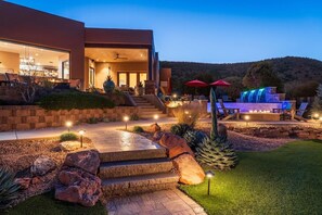 A modern house with a patio, outdoor seating, and a pool. - 5.5k Sqft Luxury Home with Large Suites, Views, Hot Tub & Firepit (Sedona)