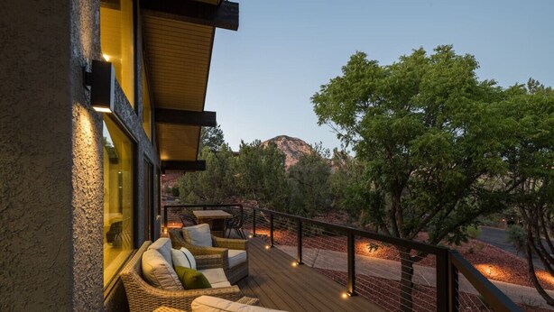 A deck with wicker furniture and a view of trees and a mountain. - Hillside Haven | Wellness Spa, Pickleball, Games (Sedona)