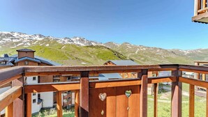 A wooden balcony with a view of snow-capped mountains. - Alpine Ski-In/Out w/MountainView (Val Thorens)
