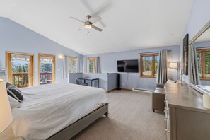 A bedroom with a bed, desk, TV, and a balcony view. - Private Bailey Mountain Retreat w/ Views (Bailey)