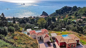 A coastal property with two labeled buildings, 'Horizon' and 'Triton', featuring a swimming pool and a view of the sea. - Villa Triton (Corfu)