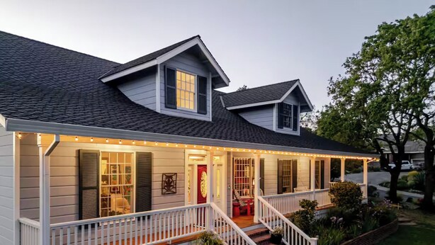 A two-story house with a covered porch, a red door, and a staircase leading to the entrance. - The Napa Sanctuary • Vineyard Views • Hot Tub (Napa)