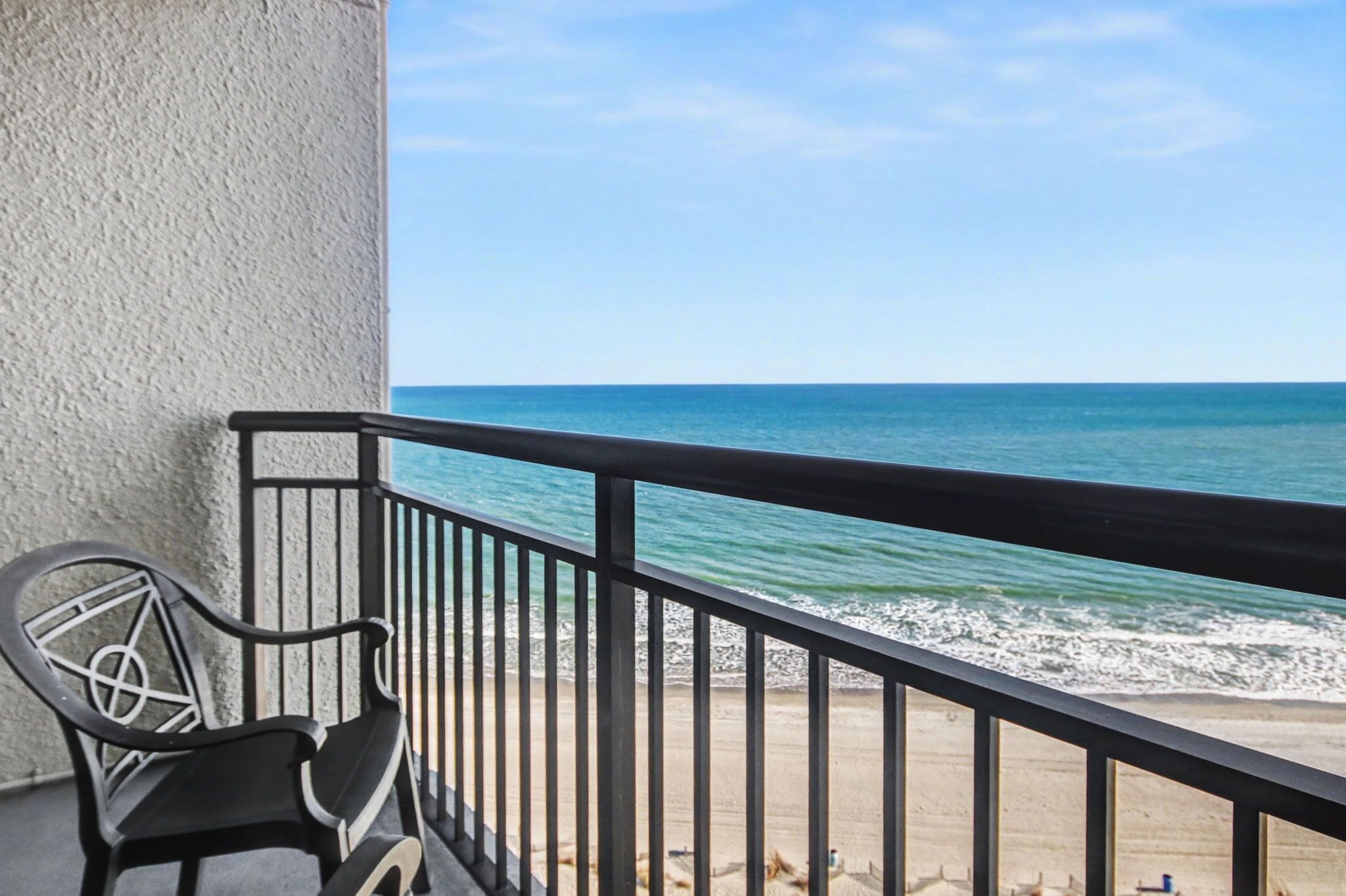 A balcony with a view of the ocean.
