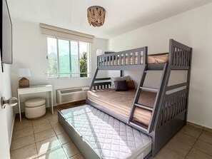 A bunk bed with a desk and a window in a room with white walls and a tiled floor. - Penthouse with Pool Near El Yunque & Luquillo Beaches (Río Grande)