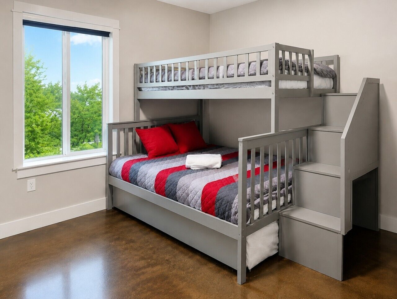 A bunk bed with a window view, a small desk, and a chair.
