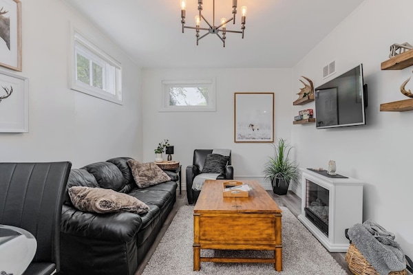 Cozy living room with soft seating, a fireplace and smart TV to stream your favorite shows.