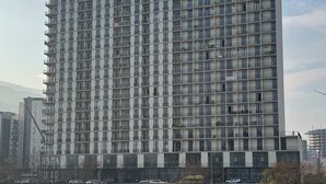A high-rise building with multiple balconies, situated by a body of water. - Premium Smart Studio with RiverView (T'bilisi)