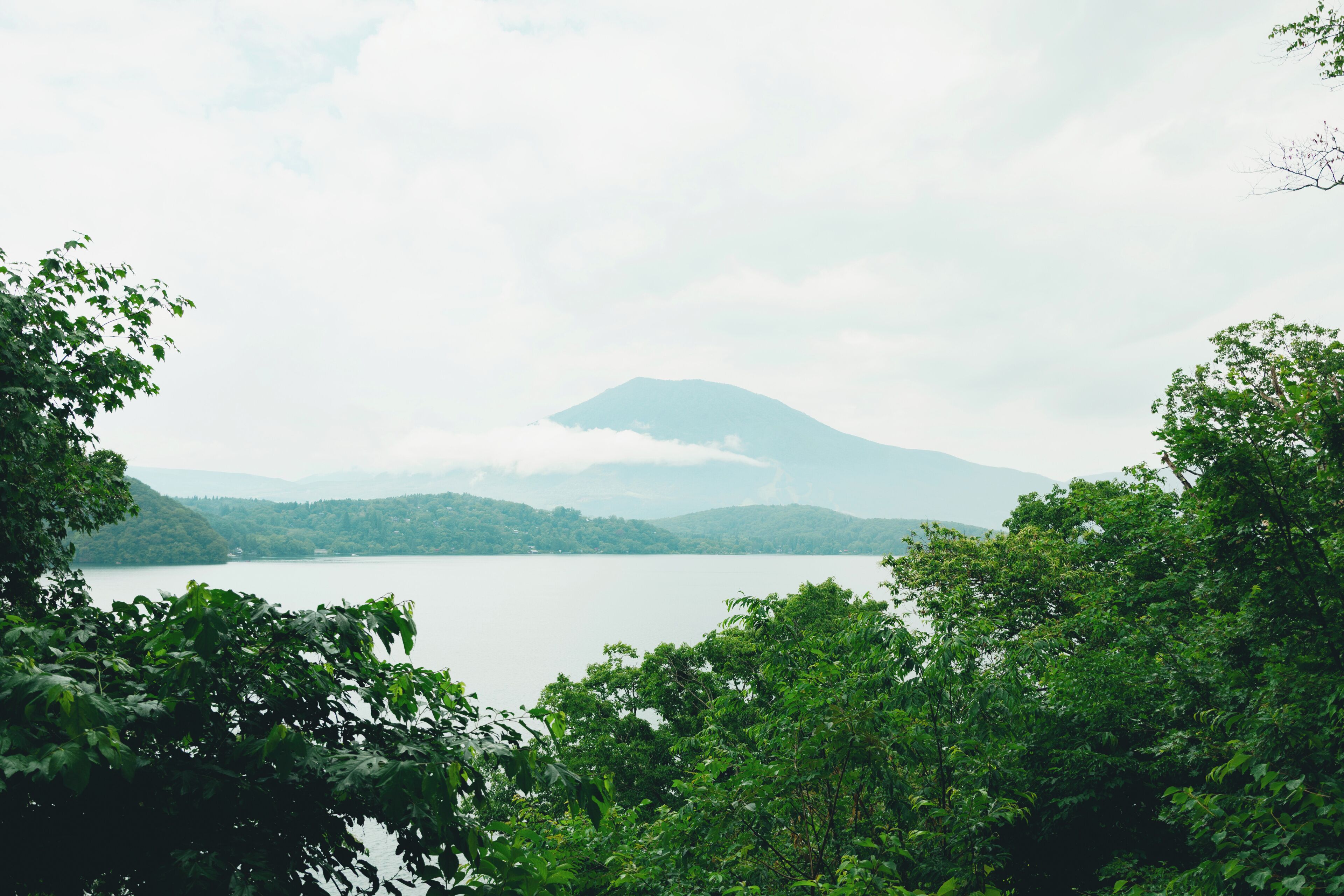A mountain landscape with a lake in the foreground and a mountain in the background.