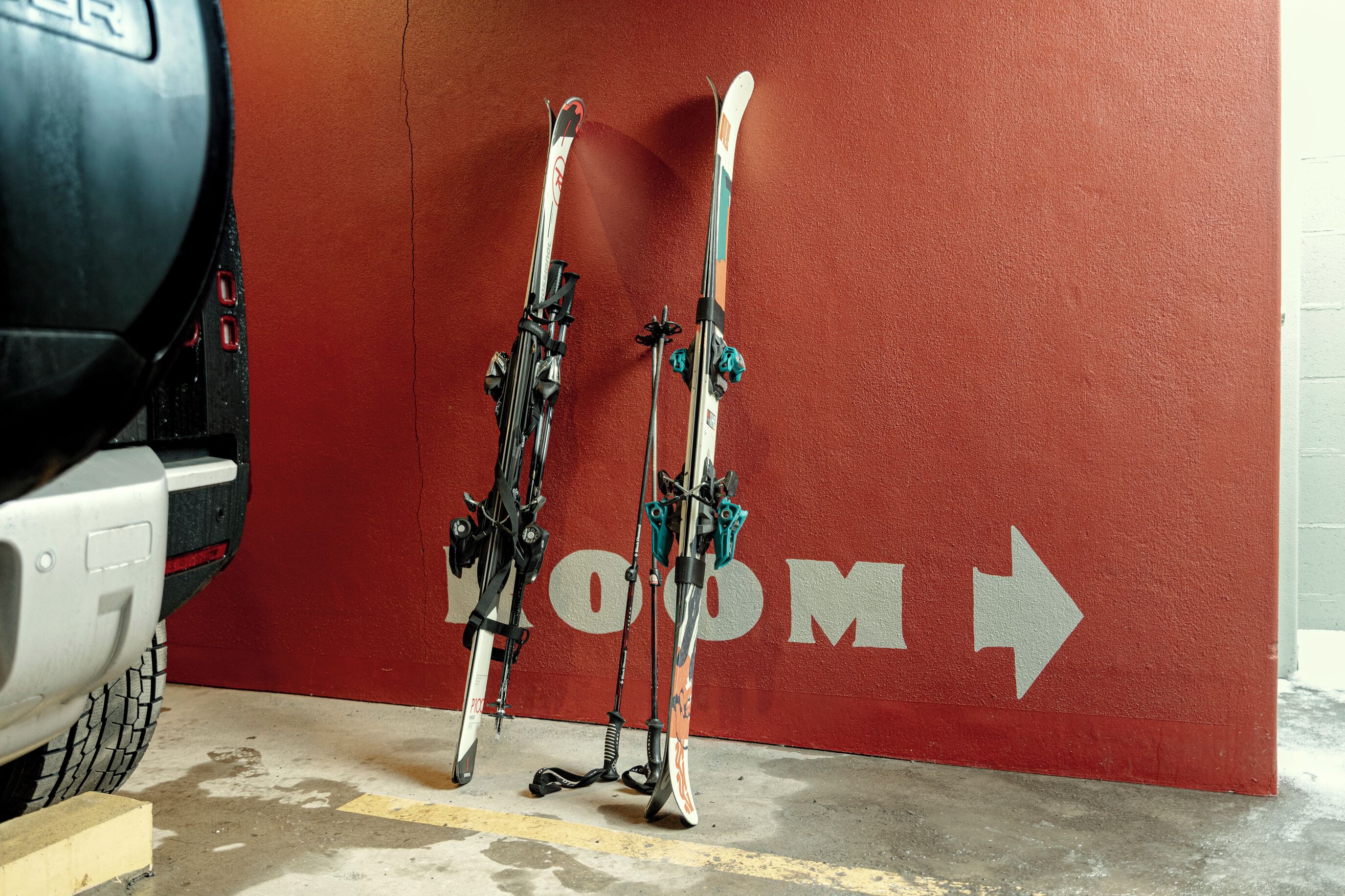 A parking garage with red walls and a directional arrow.