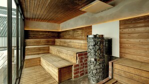 A sauna with wooden benches and a brick wall. - HOTEL&SAUNA WAYPOINT SHINANO-MYOKO (Shinano)