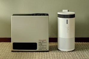 Two air conditioning units, one larger and one smaller, placed on a carpeted floor against a wall. - HOTEL&SAUNA WAYPOINT SHINANO-MYOKO (Shinano)