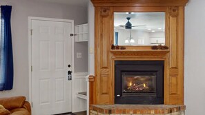 A living room with a fireplace, a white door, and a blue curtain. - Ground floor | 1min to Shuttle | Master ensuite | Snowfire 101A 2 (Angel Fire)