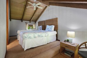 A bedroom with a bed, a nightstand, a lamp, and a ceiling fan. - Luxury Ocean-View 2BR Condo | Walk to Poipu Beach | Sleeps 6 (Koloa)