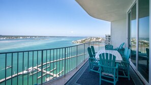 A balcony with a view of a marina and the ocean. - Coastal Three Bedroom Penthouse Offering Breathtaking Bayside Views. Complimentary Boat Slip! (Orange Beach)