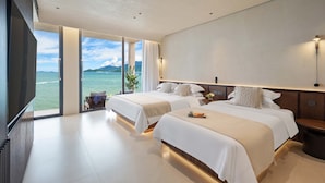 A modern hotel room with two beds, a large window offering a view of the sea, and a flat-screen TV mounted on the wall. - Santa Monica Seaview Vacation Home (Shenzhen)