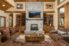 Great room with leather seating and a stone fireplace - Luxury 4 BR Mountain Escape: Views, Hot Tub & Pool Table (Banner Elk)