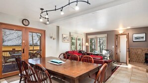 Un comedor con una mesa y sillas de madera, un sofá y una chimenea.