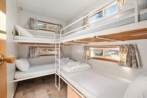 A bunk bed room with a window, curtains, and a door. - Tiny Away Stay – Laanecoorie Lakeside (Laanecoorie)