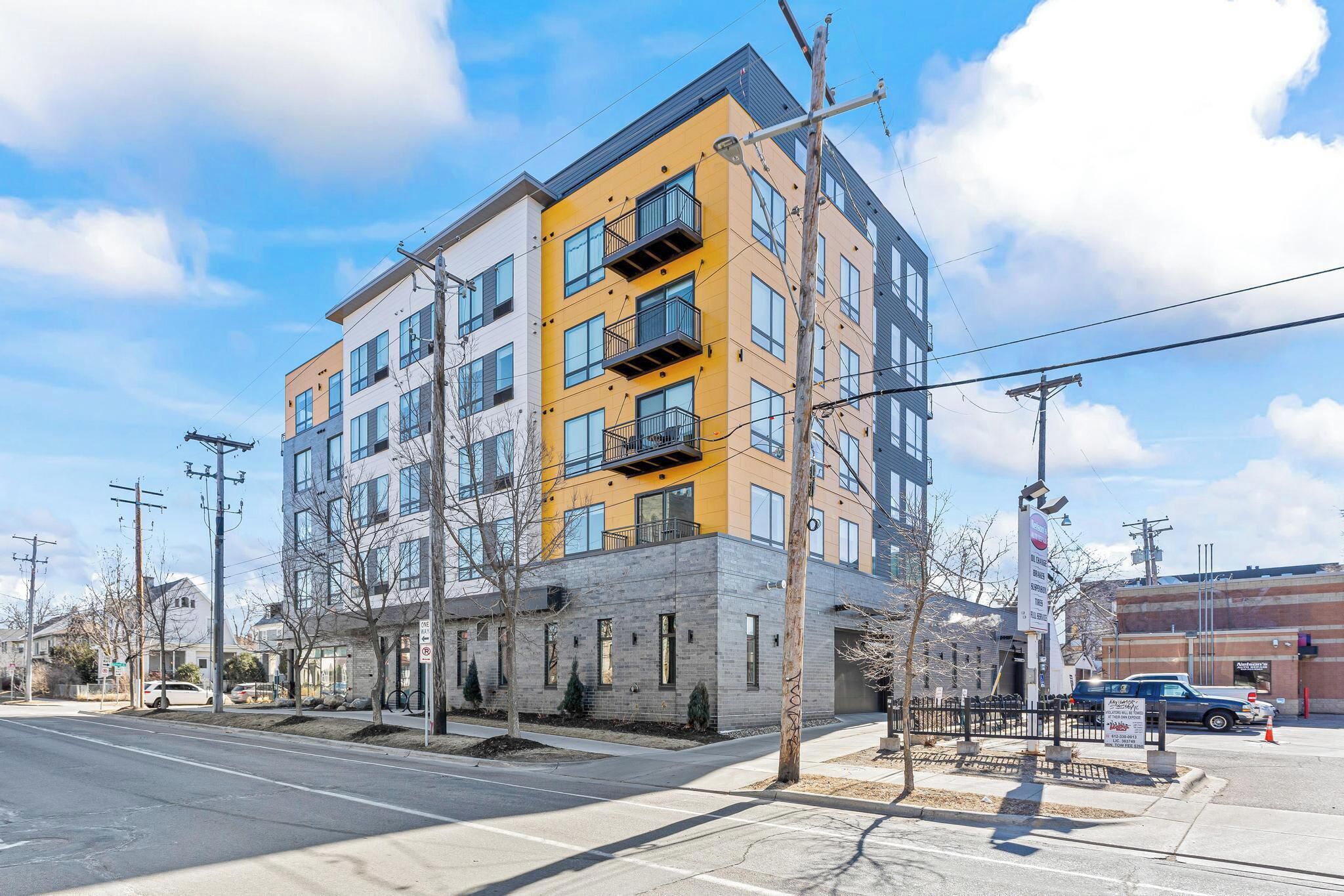 A multi-story building with a modern architectural design, featuring balconies and large windows.