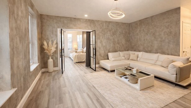 Ein modernes Wohnzimmer mit einem großen Ecksofa, einem Glastisch und einem minimalistischen Design.
