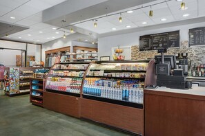 A grocery store interior with refrigerated sections, a coffee bar, and a visible menu board. - Amazing Westin Villas with fantastic amenities! Great for families! (Palm Desert)