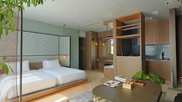A modern bedroom with a bed, bedside table, and a round table with a bench.
