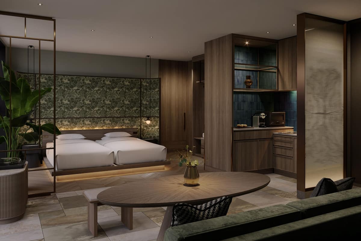 A modern bedroom with a large bed, bedside tables, a round dining table, and a seating area.