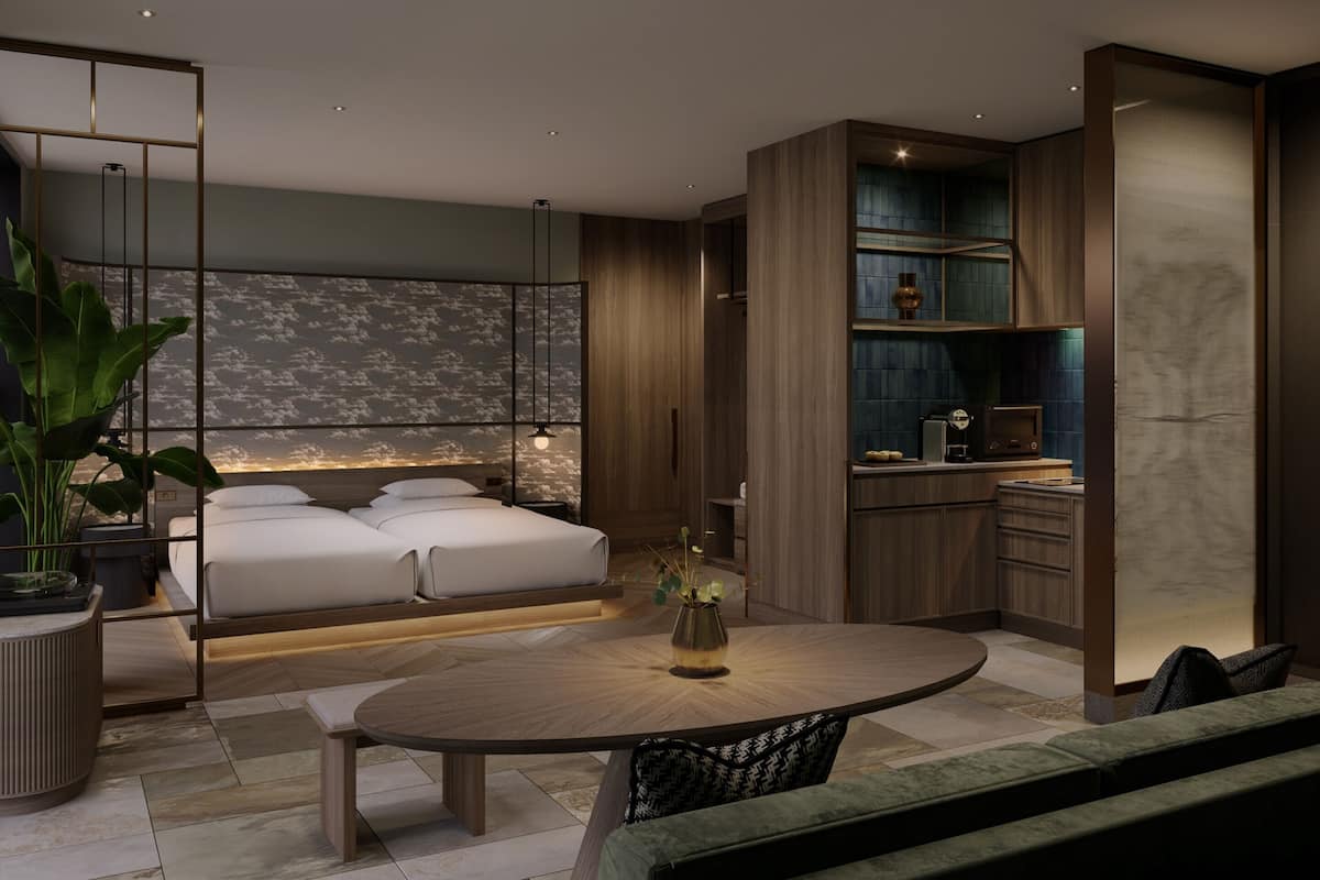 A modern bedroom with a bed, bedside table, and a large window with a view of the sky.