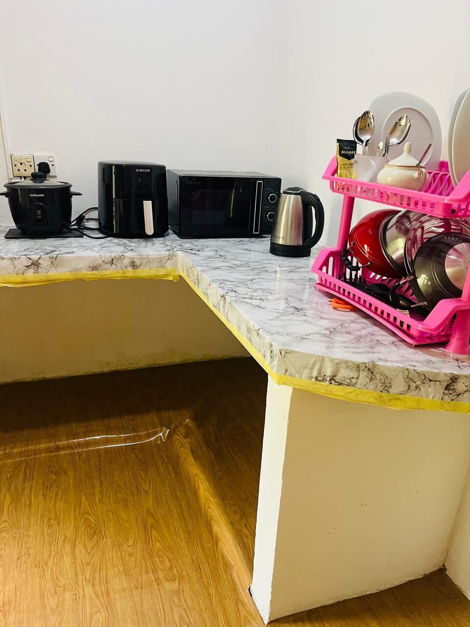 Microwave, cookware/dishes/utensils, cleaning supplies, paper towels