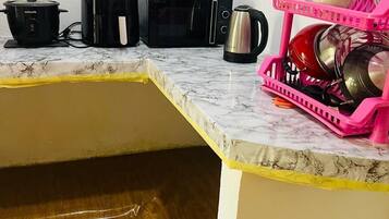 Microwave, cookware/dishes/utensils, cleaning supplies, paper towels