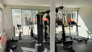 A gym with exercise equipment, a large window, and a red exercise ball. - OCEAN AND BEACH VIEW ROOFTOP (Boca Chica)