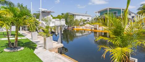 A pool area with a clear view of the surrounding landscape, including a building and palm trees.
