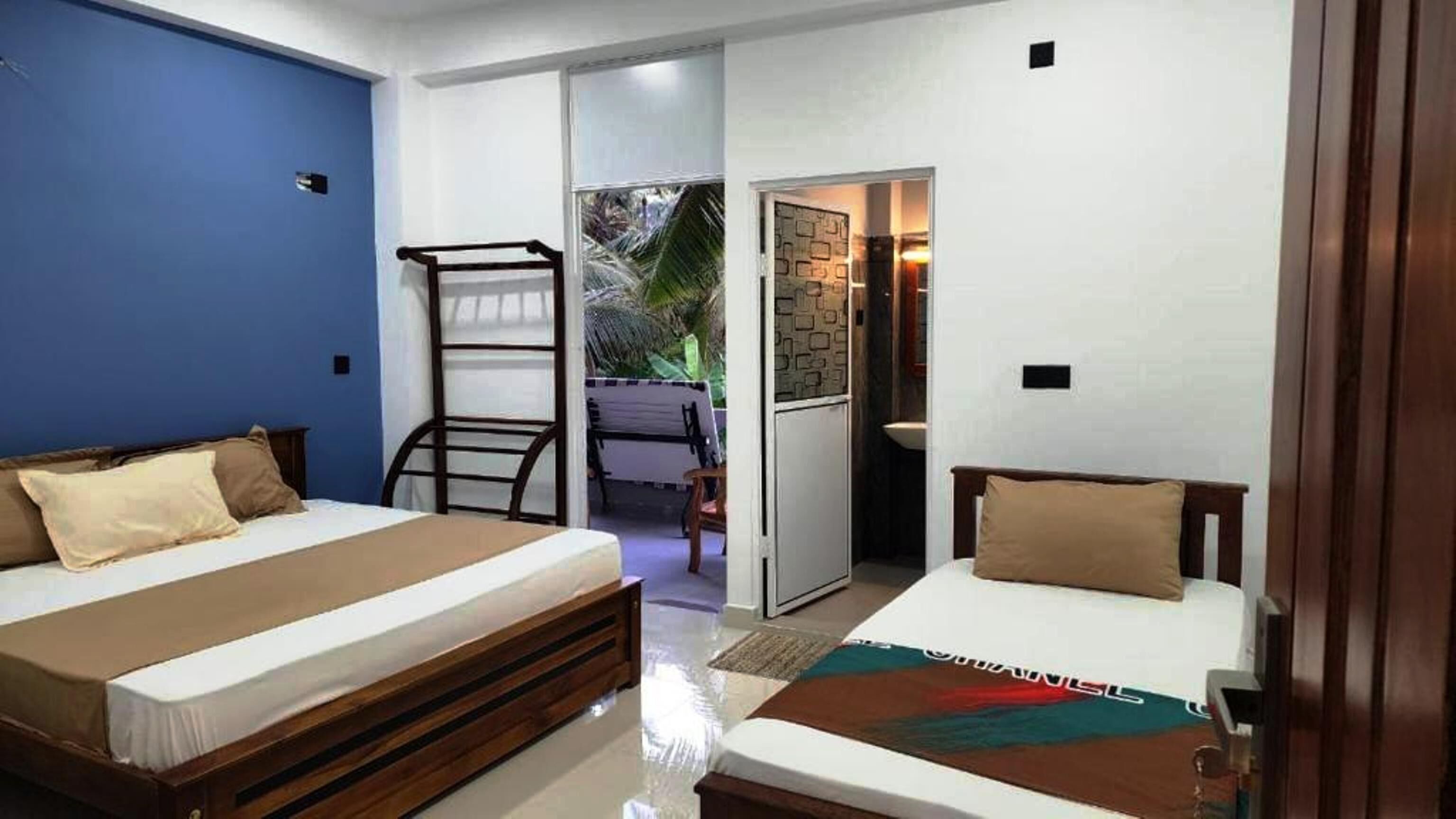 Family Triple Room, Garden View | In-room safe, desk, laptop workspace, blackout curtains
