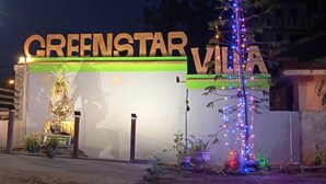 The exterior of the GreenStar Villa with illuminated signage and decorative plants. - Green star villa (Jaffna)