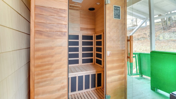 A sauna with a wooden interior, a bench, and a glass door. - Main St Apt w/ Pool Table & Sauna in Westernport! (Westernport)