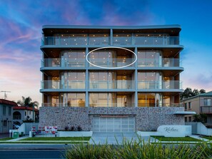 A multi-story hotel with a stone facade, balconies, and large windows. - Kailani 302: Luxury Waterfront, Bay & Marina Views (Batemans Bay)