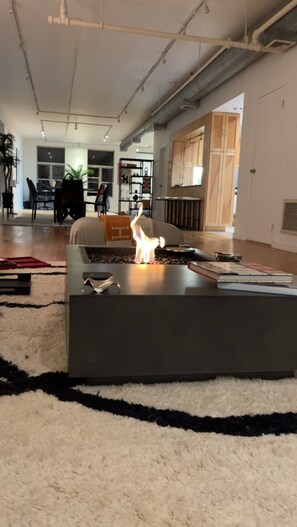 A modern living room with a central coffee table featuring a small, lit sculpture. - 2k square foot SoHo loft with private keyed elevator (New York)