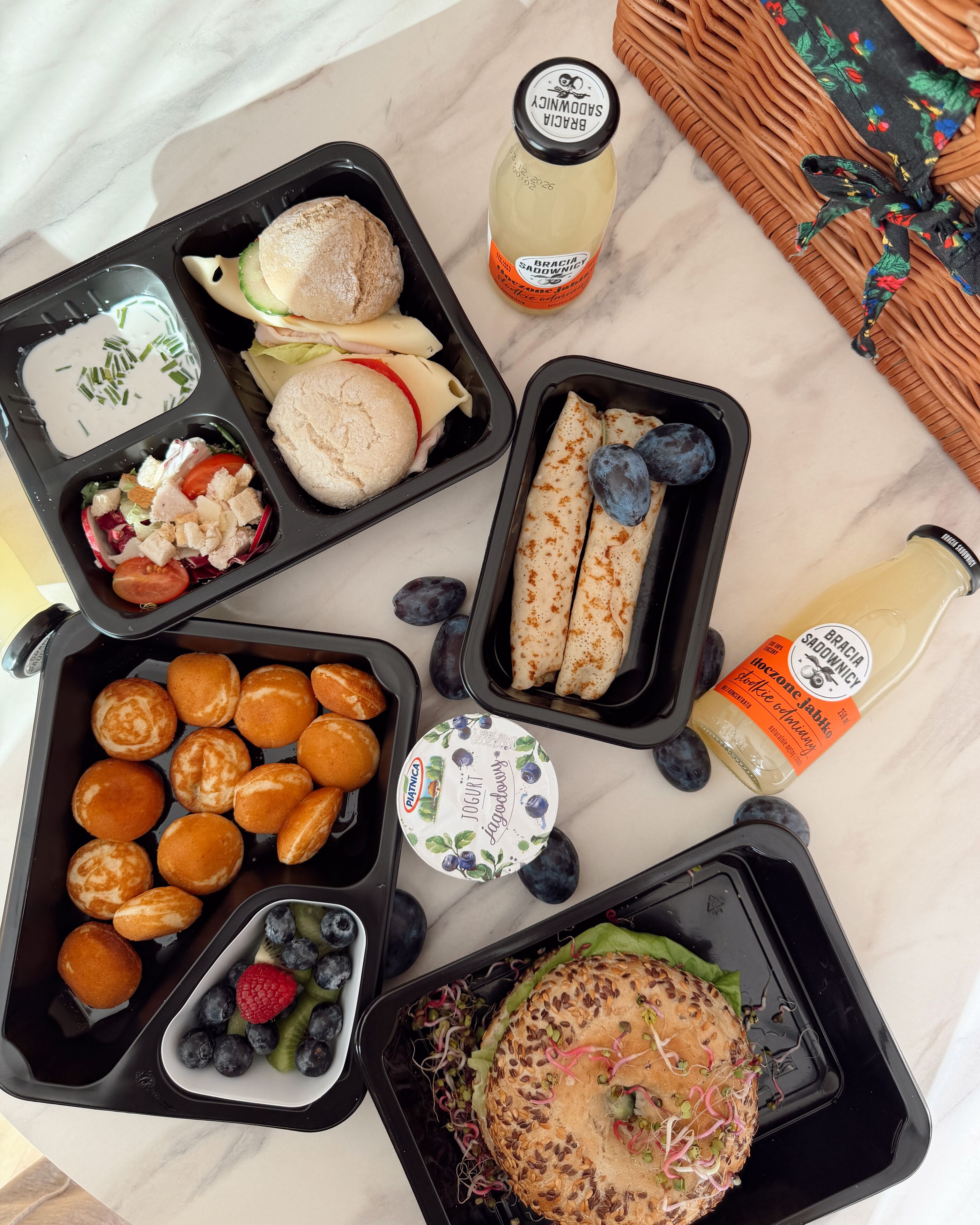A meal with various food items and condiments on a marble surface.