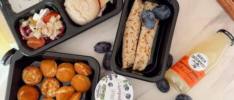 A meal with various food items and condiments on a marble surface.