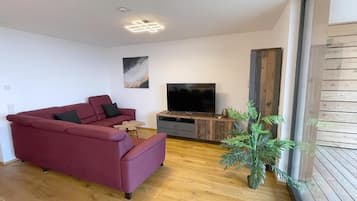 Apartamento, balcón, vistas al lago | Zona de estar | Smart TV de 55 pulgadas con canales por satélite