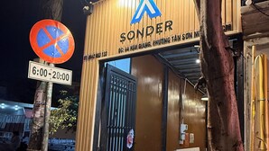 A building with a sign reading "Sonder" and a no parking sign. - Sonder Hau Giang Hotel (Ho Chi Minh City)