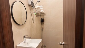 A bathroom with a sink, mirror, towel rack, and shower. - Sonder Hau Giang Hotel (Ho Chi Minh City)