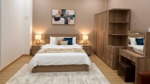 A modern bedroom with a large bed, wooden headboard, bedside lamps, and a built-in wardrobe with a mirror. - Sonder Hau Giang Hotel (Tan Binh)