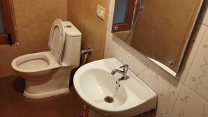 A bathroom with a toilet and a sink. - Townhouse Naksalbari Railway Station (Siliguri)